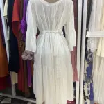 White, long-sleeved, tiered maxi dress featuring a fitted waist and flared cuffs. Free Size