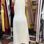 A-line Silhouette and three large yellow floral or button-like embellishments down the center.