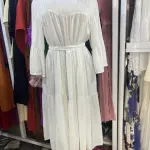 White, long-sleeved, tiered maxi dress featuring a fitted waist and flared cuffs. Free Size