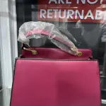 Hermès Constance Bag Trapezoidal shape, a prominent "H" clasp on the front, and a Single Top Handle with distinctive gold-tone hardware.