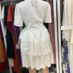 A-line tiered Dress | a Ruffled Shirt Dress with a Lapel Collar and short sleeves, tapering into a multi-layered, tiered skirt that creates a flared, voluminous silhouette.