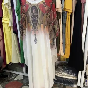 White Kaftan Maxi Dress with a distinctive Butterfly or wing-like Silhouette and Decorative patterns.