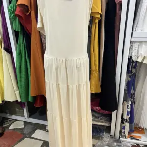 Long-Sleeved, Single-Breasted Pleated Shirt Dress.