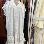 White Cotton Lace Kaftan or Maxi Dress, with Silhouette, tiered Ruffles, and intricate lace detailing.
