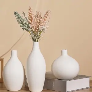 white ceramic flower arrangement vase