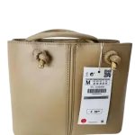 ZARA Mini City Bag with decorative knot details on the handles.