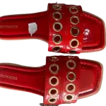 Berness Red Patent Grommet Slide Sandals.