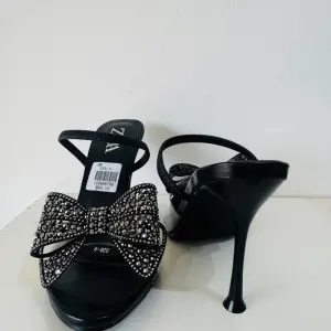 Zara Bow High Heel Sandals in a diamante-encrusted bow on the instep and a side buckle.