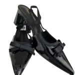 Black patent slingback block pump heels in a pointed toe and bow accent.