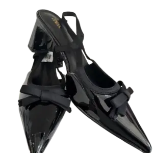 Black patent slingback block pump heels in a pointed toe and bow accent.