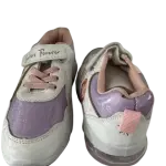 White and purple children's sneakers feature pink laces and hook-and-loop straps labeled "Sisters Forever
