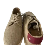 Casual low-top lace-up sneakers, in a textured canvas material.