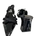 Black patent slingback block pump heels in a pointed toe and bow accent.